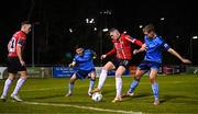 6 March 2023; Ryan Graydon of Derry City in action against Brendan Barr, left and Mark Dignam of UCD during the SSE Airtricity Men's Premier Division match between UCD and Derry City at the UCD Bowl in Dublin. Photo by Stephen McCarthy/Sportsfile