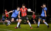 6 March 2023; Brandon Kavanagh of Derry City in action against Harvey O'Brien, left, and Donal Higgins of UCD during the SSE Airtricity Men's Premier Division match between UCD and Derry City at the UCD Bowl in Dublin. Photo by Stephen McCarthy/Sportsfile