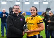 8 March 2023; Molly Carthy of DCU Dóchas Éireann in presented with the Player of the Match award by Connacht LGFA President Con Moynihan after her side's victory in the 2023 Yoplait Ladies HEC Cup Final match between DCU Dóchas Éireann and Ulster University Magee at University of Galway Connacht GAA Air Dome in Bekan, Mayo. Photo by Piaras Ó Mídheach/Sportsfile