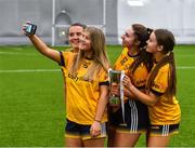 8 March 2023; DCU Dóchas Éireann players, from left, Leah McArdle, Molly Carthy, Leah Dormer and Fainche Grimes take a selfie after their side's victory in the 2023 Yoplait Ladies HEC Cup Final match between DCU Dóchas Éireann and Ulster University Magee at University of Galway Connacht GAA Air Dome in Bekan, Mayo. Photo by Piaras Ó Mídheach/Sportsfile