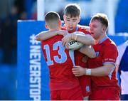 10 March 2023; Niall Cox of CUS, centre, celebrates with teammates Conn Doherty, left, and Lucas Maguire after scoring their side's third try during the Bank of Ireland Vinnie Murray Cup Final match between CUS and St Andrew's College at Energia Park in Dublin. Photo by Seb Daly/Sportsfile