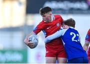 10 March 2023; Senan Campbell of CUS is tackled by Simon O'Kelly of St Andrew's College during the Bank of Ireland Vinnie Murray Cup Final match between CUS and St Andrew's College at Energia Park in Dublin. Photo by Seb Daly/Sportsfile
