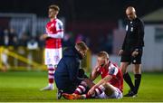 10 March 2023; Tom Grivosti of St Patrick's Athletic receives medical attention from St Patrick's Athletic head of medical Sam Rice during the SSE Airtricity Men's Premier Division match between St Patrick's Athletic and Bohemians at Richmond Park in Dublin. Photo by Stephen McCarthy/Sportsfile