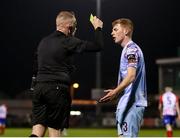 10 March 2023; Can Browne of Cobh Ramblers is shown a yellow card by referee Jason Moore during the SSE Airtricity Men's First Division match between Treaty United and Cobh Ramblers at Markets Field in Limerick. Photo by Michael P Ryan/Sportsfile