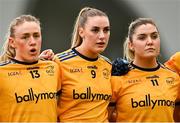 11 March 2023; DCU Dóchas Éireann players, from left, Emma Morrissey, Chloe Darby and Maria Reilly stand for Amhrán na bhFiann before the 2023 Yoplait Ladies HEC O’Connor Cup Final match between DCU Dóchas Éireann and University of Limerick at University of Galway Connacht GAA Air Dome in Bekan, Mayo. Photo by Piaras Ó Mídheach/Sportsfile