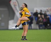 11 March 2023; DCU Dóchas Éireann captain Anna Rose Kennedy is held aloft by teammate Emma Morrissey as they celebrate after their side's victory in the 2023 Yoplait Ladies HEC O’Connor Cup Final match between DCU Dóchas Éireann and University of Limerick at University of Galway Connacht GAA Air Dome in Bekan, Mayo. Photo by Piaras Ó Mídheach/Sportsfile