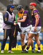 12 March 2023; Liam Óg McGovern of Wexford, centre, attempts dry his hurley with the help of Paudie Reidy, left, during the Allianz Hurling League Division 1 Group A match between Cork and Wexford at Páirc Ui Chaoimh in Cork. Photo by Eóin Noonan/Sportsfile