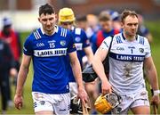12 March 2023; Aaron Dunphy, left, and Laois goalkeeper Enda Rowland after the Allianz Hurling League Division 1 Group A match between Antrim and Laois at Corrigan Park in Belfast. Photo by Ramsey Cardy/Sportsfile
