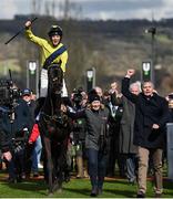 14 March 2023; Jockey Michael O'Sullivan, and winning owner Barry Connell, right, celebrate as he is led in to the winners enclosure, after Marine Nationalehad won the Sky Bet Supreme Novices' Hurdle during day one of the Cheltenham Racing Festival at Prestbury Park in Cheltenham, England. Photo by Seb Daly/Sportsfile