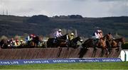 14 March 2023; A view of the field as horses and jockeys jump the second fence during the Ultima Handicap Chase during day one of the Cheltenham Racing Festival at Prestbury Park in Cheltenham, England. Photo by Seb Daly/Sportsfile