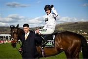 14 March 2023; Jockey Nico de Boinville celebrates on Constitution Hill, with handler Jaydon Lee, after the Unibet Champion Hurdle Challenge Trophy during day one of the Cheltenham Racing Festival at Prestbury Park in Cheltenham, England. Photo by Harry Murphy/Sportsfile