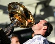 14 March 2023; Jockey Nico de Boinville celebrates as he kisses the Champion Hurdle Challenge Trophy after the Unibet Champion Hurdle Challenge Trophy during day one of the Cheltenham Racing Festival at Prestbury Park in Cheltenham, England. Photo by Seb Daly/Sportsfile