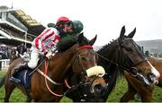 15 March 2023; Jockey Sam Twiston-Davies on The Real Whacker, left, is congratulated by third place Jockey Daryl Jacob on Bronn after winning the Brown Advisory Novices' Chase during day two of the Cheltenham Racing Festival at Prestbury Park in Cheltenham, England. Photo by Seb Daly/Sportsfile