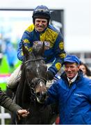 15 March 2023; Jockey Harry Skelton celebrates on Lander Dan, as they are led into the winners enclosure by groom Stephen Petch, right, after winning the Coral Cup Handicap Hurdle during day two of the Cheltenham Racing Festival at Prestbury Park in Cheltenham, England. Photo by Harry Murphy/Sportsfile