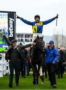 15 March 2023; Jockey Harry Skelton celebrates on Lander Dan, as they are led into the winners enclosure by owner Colm Donlon, left, and groom Stephen Petch, right, after winning the Coral Cup Handicap Hurdle during day two of the Cheltenham Racing Festival at Prestbury Park in Cheltenham, England. Photo by Harry Murphy/Sportsfile