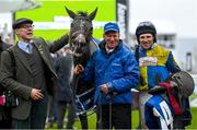 15 March 2023; Winning connections of Langer Dan, from left, owner Colm Donlon, groom Stephen Petch, jockey Harry Skelton after winning the Coral Cup Handicap Hurdle during day two of the Cheltenham Racing Festival at Prestbury Park in Cheltenham, England. Photo by Harry Murphy/Sportsfile