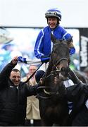 15 March 2023; Jockey Paul Townend celebrates on Energumene, as they are led into the winner's enclosure by owner Tony Bloom, left, after winning the Betway Queen Mother Champion Chase during day two of the Cheltenham Racing Festival at Prestbury Park in Cheltenham, England. Photo by Harry Murphy/Sportsfile