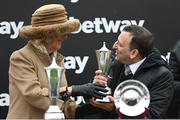 15 March 2023; Camilla, Queen Consort, presents owner Tony Bloom with his trophy after winning the Betway Queen Mother Champion Chase, with Energumene, on day two of the Cheltenham Racing Festival at Prestbury Park in Cheltenham, England. Photo by Harry Murphy/Sportsfile