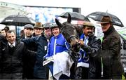 15 March 2023; Energumene with winning connections, including owner Tony Bloom, left, jockey Paul Townend, groom Imran Haider and trainer Willie Mullins after winning the Betway Queen Mother Champion Chase on day two of the Cheltenham Racing Festival at Prestbury Park in Cheltenham, England. Photo by Harry Murphy/Sportsfile