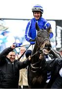 15 March 2023; Energumene, with Paul Townend up, are led into the winner's enclosure by owner Tony Bloom, left, after winning the Betway Queen Mother Champion Chase during day two of the Cheltenham Racing Festival at Prestbury Park in Cheltenham, England. Photo by Harry Murphy/Sportsfile