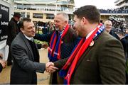 15 March 2023; Winner owner Tony Bloom, owner and chairman of Premier League football club Brighton & Hove Albion, who sent out Energumene to win the Betway Queen Mother Champion Chase, is congratulated by owners of fourth placed Editeur Du Gite, and Crystal Palace supporters, Steve and Sean Peston, on day two of the Cheltenham Racing Festival at Prestbury Park in Cheltenham, England. Photo by Seb Daly/Sportsfile