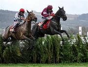 15 March 2023; Delta Work, with Keith Donoghue up, jumps the last ahead of second placed Galvin, with Davy Russell up, on their way to winning the Glenfarclas Cross Country Chase on day two of the Cheltenham Racing Festival at Prestbury Park in Cheltenham, England. Photo by Harry Murphy/Sportsfile