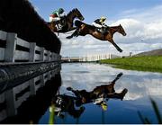 14 March 2023; Iceo Madrik, with Jack Tudor up, left, and Laskalin, with Shane Quinlan up, jump the waterjump during day one of the Cheltenham Racing Festival at Prestbury Park in Cheltenham, England. Photo by Harry Murphy/Sportsfile