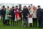 15 March 2023; Delta Work and connections, including jockey Keith Donoghue, injured jockey Jack Kennedy, owner Michael O'Leary and wife Anita and trainer Gordon Elliott, right, after winning the Glenfarclas Cross Country Chase on day two of the Cheltenham Racing Festival at Prestbury Park in Cheltenham, England. Photo by Harry Murphy/Sportsfile