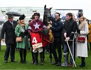 15 March 2023; Delta Work and connections, including jockey Keith Donoghue, injured jockey Jack Kennedy and Anita O'Leary, wife of owner Michael O'Leary after winning the Glenfarclas Cross Country Chase on day two of the Cheltenham Racing Festival at Prestbury Park in Cheltenham, England. Photo by Harry Murphy/Sportsfile