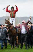 16 March 2023; Winning owner Niall Reilly, right, leads Good Time Jonny, with Liam McKenna up, after they had won the Pertemps Network Final Handicap Hurdle during day three of the Cheltenham Racing Festival at Prestbury Park in Cheltenham, England. Photo by Seb Daly/Sportsfile