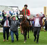 16 March 2023; Winning owners Charlie Gavigan, left, Aidan Shiels and Niall Reilly, right, lead Good Time Jonny, with Liam McKenna up, after they had won the Pertemps Network Final Handicap Hurdle during day three of the Cheltenham Racing Festival at Prestbury Park in Cheltenham, England. Photo by Seb Daly/Sportsfile