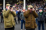 16 March 2023; Punters watch the concluding stages of the Jack De Bromhead Mares' Novices' Hurdle during day three of the Cheltenham Racing Festival at Prestbury Park in Cheltenham, England. Photo by Harry Murphy/Sportsfile