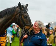 16 March 2023; Groom Chrissie Dunne with You Wear It Well, in the parade ring, after winning the Jack De Bromhead Mares' Novices' Hurdle during day three of the Cheltenham Racing Festival at Prestbury Park in Cheltenham, England. Photo by Seb Daly/Sportsfile