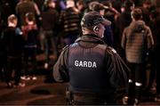 16 March 2023; A member of An Garda Síochána's public order unit watches on as supporters arrive for the SSE Airtricity Men's Premier Division match between Drogheda United and Dundalk at Weavers Park in Drogheda, Louth. Photo by Stephen McCarthy/Sportsfile