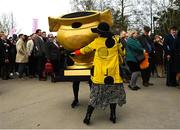 17 March 2023; A Gold Cup mascot dances with a racegoer before racing on day four of the Cheltenham Racing Festival at Prestbury Park in Cheltenham, England. Photo by Harry Murphy/Sportsfile