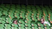 17 March 2023; Amy and Sophie Sexton, daughters of Ireland captain Jonathan Sexton, play 'hide & seek' during the Ireland rugby captain's run at the Aviva Stadium in Dublin. Photo by Ramsey Cardy/Sportsfile