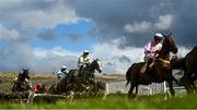 17 March 2023; The eventual winner, Lossiemouth, 14, with Paul Townend up, in the middle of the field as the jump the last, first time round, on their way to win the JCB Triumph Hurdle during day four of the Cheltenham Racing Festival at Prestbury Park in Cheltenham, England. Photo by Harry Murphy/Sportsfile