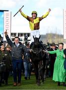 17 March 2023; Winning owner Audrey Turley leads jockey Paul Townend as he celebrates on Galopin Des Champs after winning the Boodles Cheltenham Gold Cup Chase during day four of the Cheltenham Racing Festival at Prestbury Park in Cheltenham, England. Photo by Harry Murphy/Sportsfile
