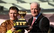 17 March 2023; Winning jockey Paul Townend and trainer Willie Mullins celebrate with the Gold Cup after Galopin Des Champs had won the Boodles Cheltenham Gold Cup Chase during day four of the Cheltenham Racing Festival at Prestbury Park in Cheltenham, England. Photo by Harry Murphy/Sportsfile