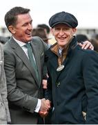 17 March 2023; Winning trainer Colm Murphy, right, is congratulated by former champion jockey Sir A P McCoy after he had sent out Impervious to win the Mrs Paddy Power Mares' Chase during day four of the Cheltenham Racing Festival at Prestbury Park in Cheltenham, England. Photo by Seb Daly/Sportsfile