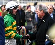 17 March 2023; Jockey Adrian Kelly is congratulated by winning owner JP McManus after Iroko won the Martin Pipe Conditional Jockeys' Handicap Hurdle during day four of the Cheltenham Racing Festival at Prestbury Park in Cheltenham, England. Photo by Harry Murphy/Sportsfile