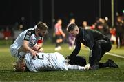 17 March 2023; John Brannefalk of Sligo Rovers is attended to by physiotherapist Cian McBride as team-mate Greg Bolger comforts him during the SSE Airtricity Men's Premier Division match between Derry City and Sligo Rovers at The Ryan McBride Brandywell Stadium in Derry. Photo by Stephen McCarthy/Sportsfile