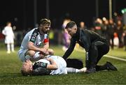 17 March 2023; John Brannefalk of Sligo Rovers is attended to by physiotherapist Cian McBride as team-mate Greg Bolger comforts him during the SSE Airtricity Men's Premier Division match between Derry City and Sligo Rovers at The Ryan McBride Brandywell Stadium in Derry. Photo by Stephen McCarthy/Sportsfile