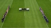 18 March 2023; Referee James Molloy, his officials and members of both squads and management, stand during a minutes silence to honour the late Liam Kearns before the Allianz Football League Division 3 match between Tipperary and Offaly at FBD Semple Stadium in Thurles, Tipperary. Photo by Ray McManus/Sportsfile