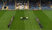 18 March 2023; Referee James Molloy, his officials and members of both squads and management, stand during a minutes silence to honour the late Liam Kearns before the Allianz Football League Division 3 match between Tipperary and Offaly at FBD Semple Stadium in Thurles, Tipperary. Photo by Ray McManus/Sportsfile