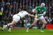 18 March 2023; Mack Hansen of Ireland evades the tackle of Henry Arundell of England during the Guinness Six Nations Rugby Championship match between Ireland and England at Aviva Stadium in Dublin. Photo by Harry Murphy/Sportsfile