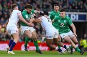 18 March 2023; Andrew Porter of Ireland is tackled by Owen Farrell, left, and Manu Tuilagi of England during the Guinness Six Nations Rugby Championship match between Ireland and England at Aviva Stadium in Dublin. Photo by Ramsey Cardy/Sportsfile