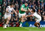18 March 2023; Robbie Henshaw of Ireland is tackled by Henry Arundell, left, and Manu Tuilagi during the Guinness Six Nations Rugby Championship match between Ireland and England at Aviva Stadium in Dublin. Photo by Harry Murphy/Sportsfile