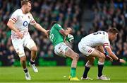 18 March 2023; Hugo Keenan of Ireland goes down after a tackle by Freddie Steward of England, resulting in a red card for Freddie Steward, during the Guinness Six Nations Rugby Championship match between Ireland and England at the Aviva Stadium in Dublin Photo by Ramsey Cardy/Sportsfile