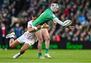 18 March 2023; Mack Hansen of Ireland is tackled by Anthony Watson of England during the Guinness Six Nations Rugby Championship match between Ireland and England at Aviva Stadium in Dublin. Photo by Ramsey Cardy/Sportsfile